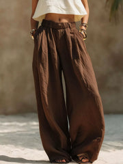 Close front view of cream wide-leg pants and gathered elastic waistband