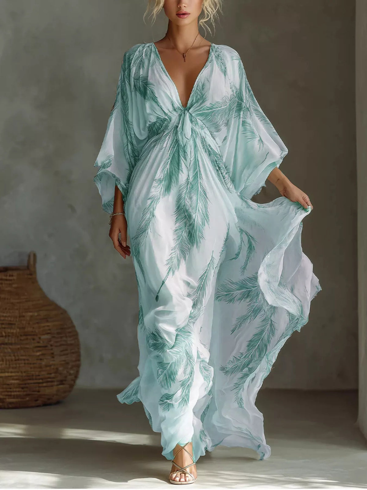 White and mint feather-print maxi dress with a tied V-neckline and loose sleeves, front view.