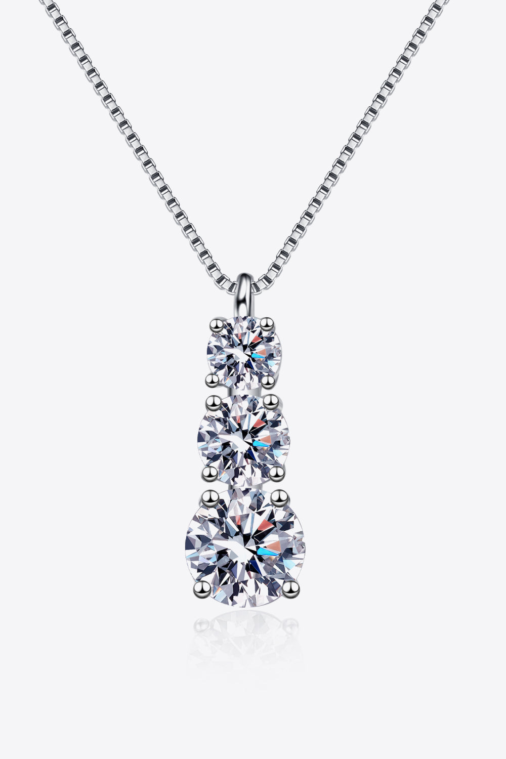 Silver necklace with three graduated crystal pendants shown on white