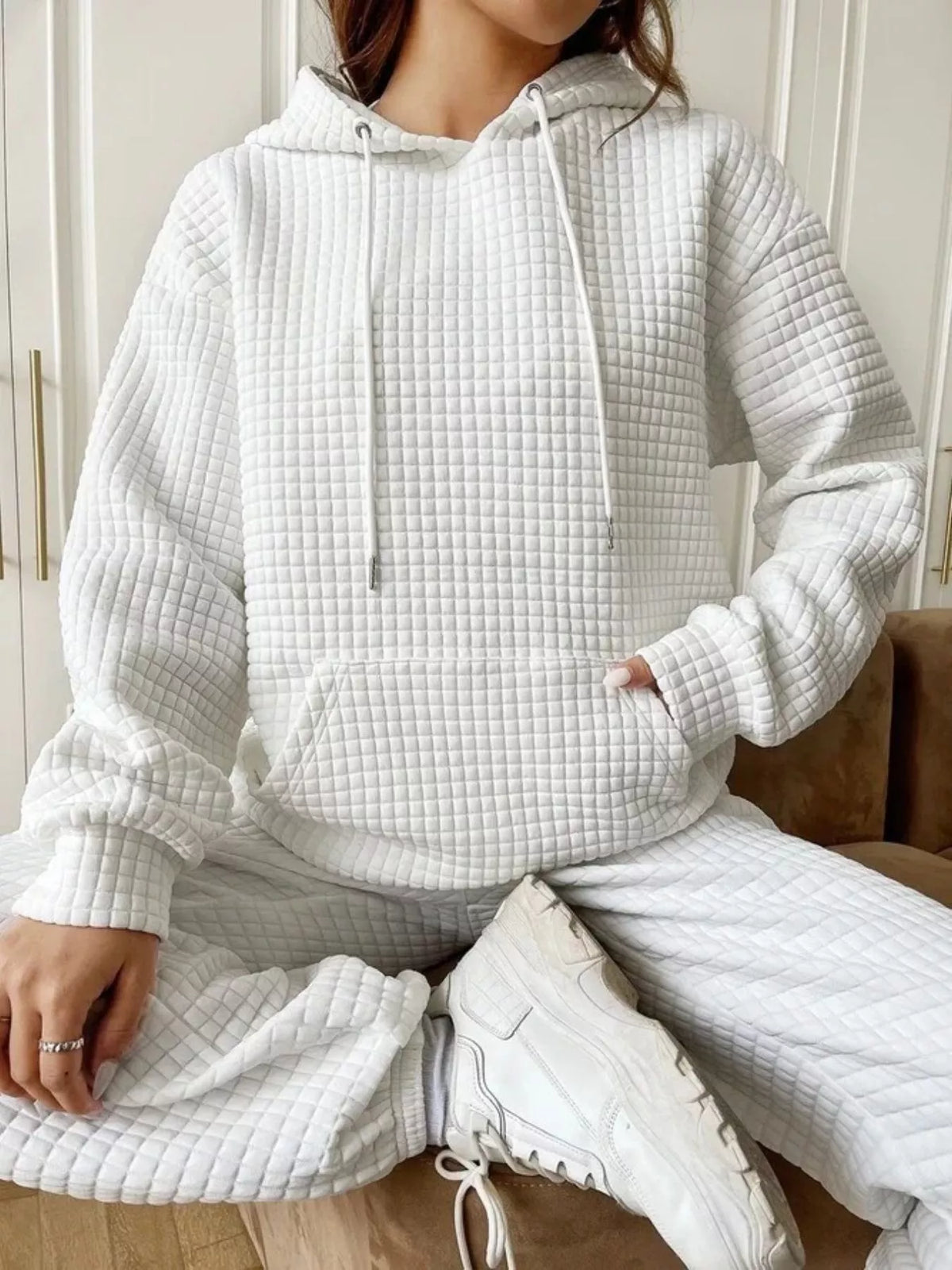White textured hoodie with drawstrings and front pocket