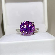 Purple round-stone ring displayed in a white jewellery box