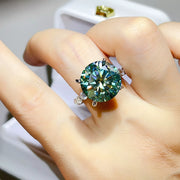 Green-blue moissanite ring worn on hand