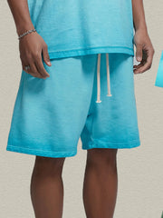 Model wearing turquoise drawstring shorts