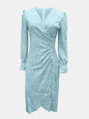 Front view of mint blue surplice midi dress with long sleeves and decorative buttons