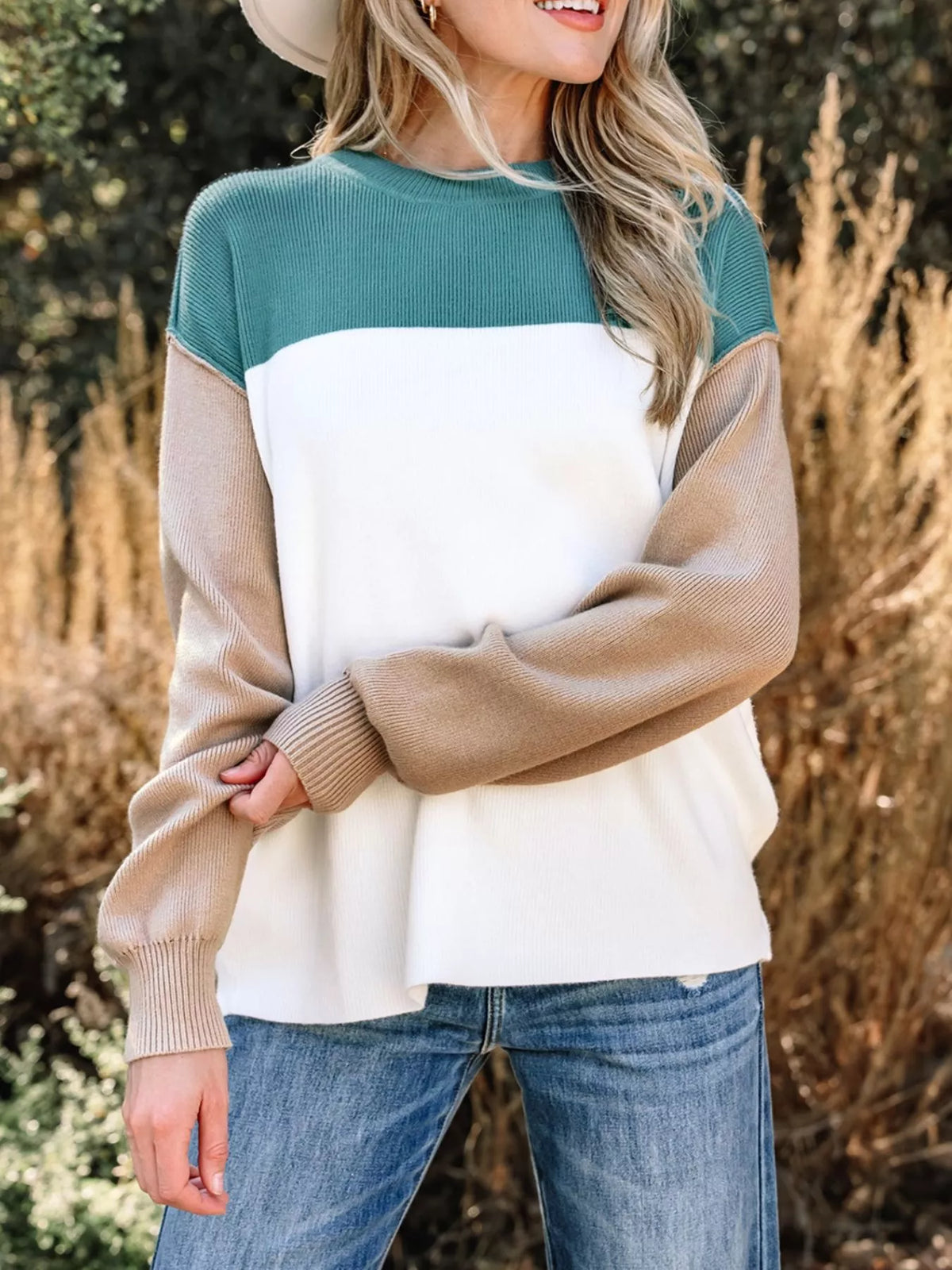 Front view of color-block sweatshirt styled with jeans