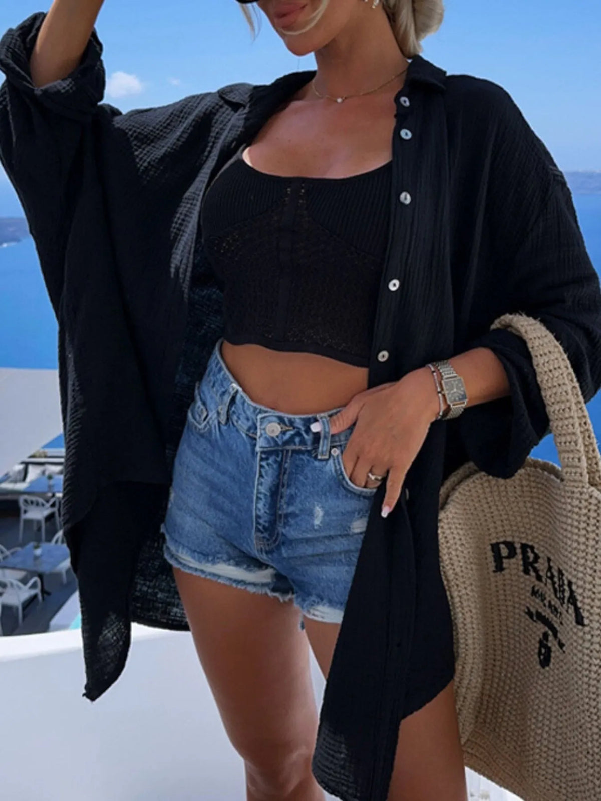 Evil eye embroidered oversized navy shirt worn open over crop top, front view