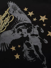 Close-up of Pegasus and star print on black T-shirt