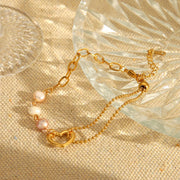 Gold-tone heart pearl bracelet arranged in a loop
