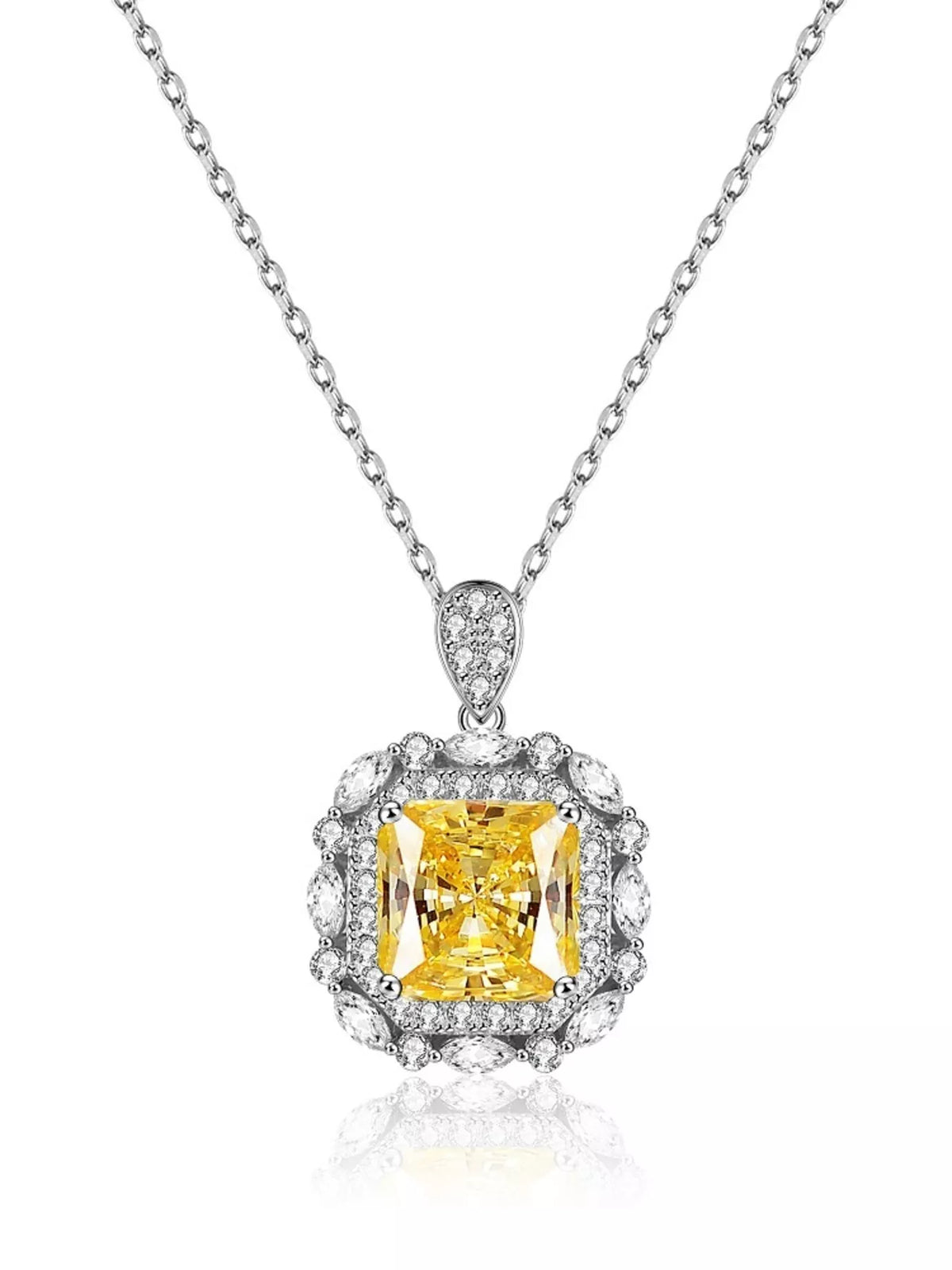 Yellow rectangular pendant necklace with decorative clear stone border on white background