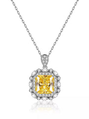 Yellow rectangular pendant necklace with decorative clear stone border on white background