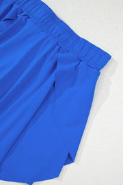 Close-up of blue skort's overlapping skirt panels and side seam