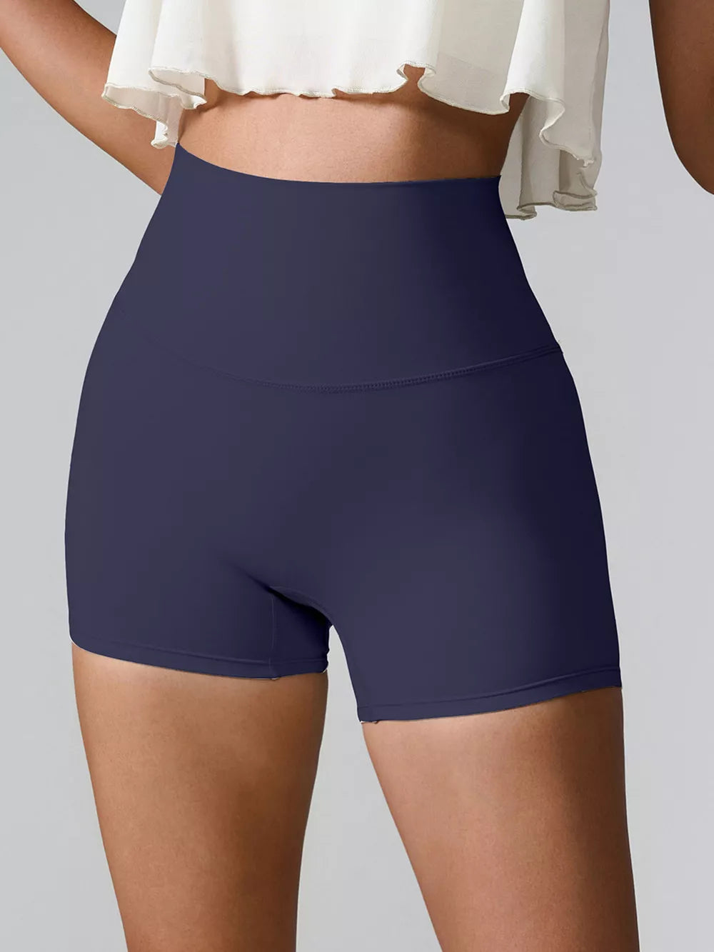 Back view of deep navy high-waist active shorts.