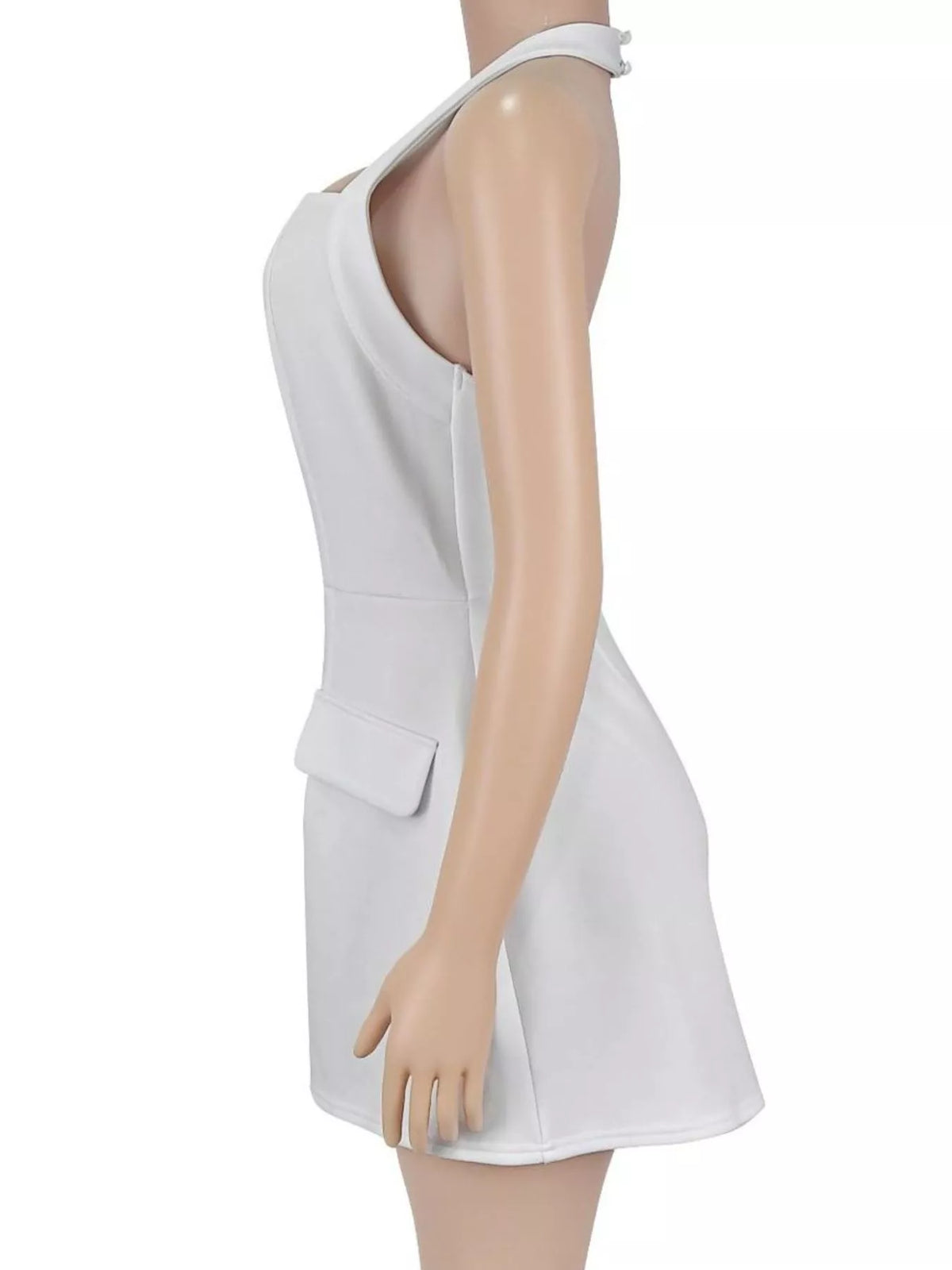 Side view of the white halter mini dress on a mannequin showing the open back and pocket flap.