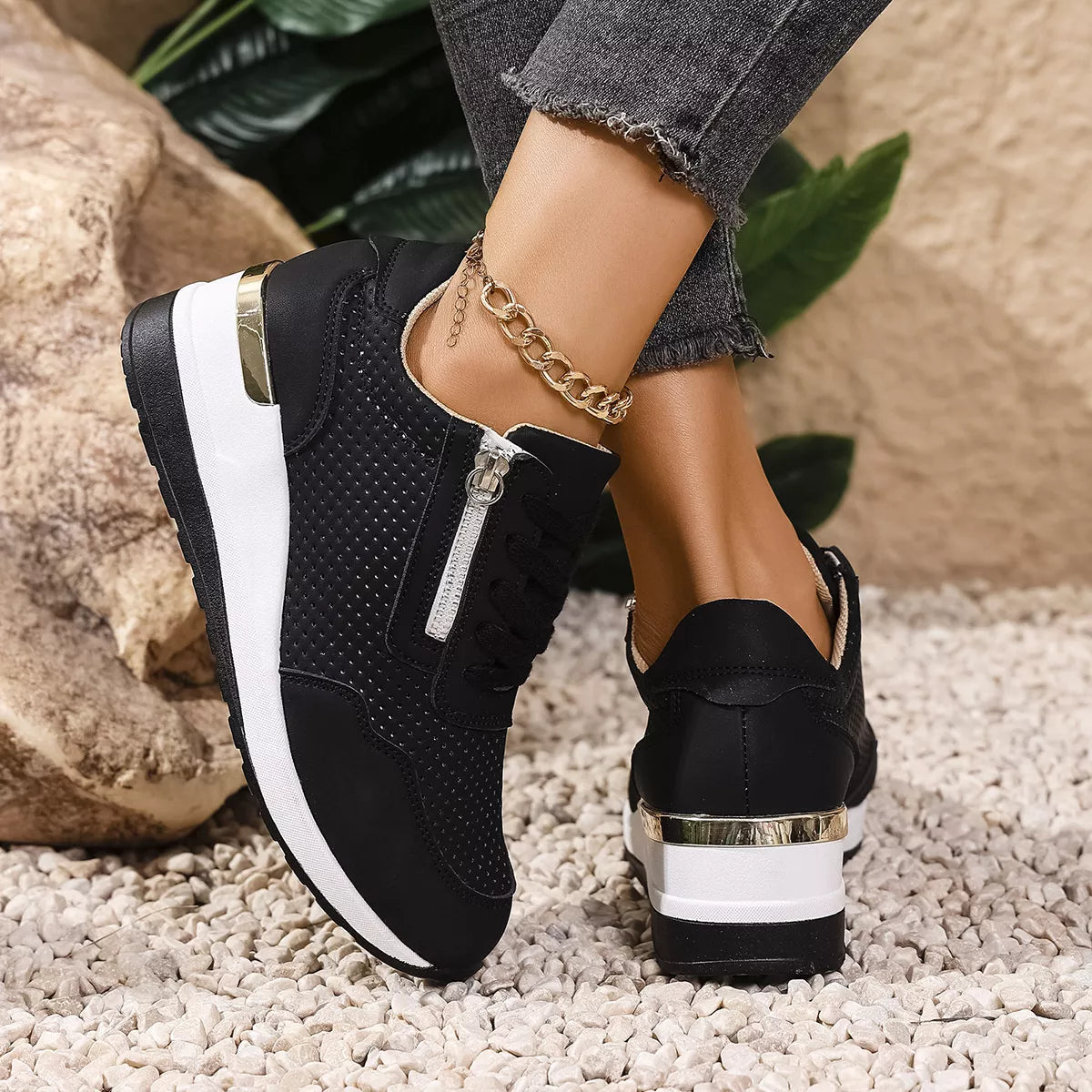 Back and side view of black sneakers showing white wedge sole and heel