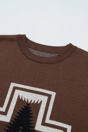 Close-up of brown tee crew neckline and western cross chest graphic