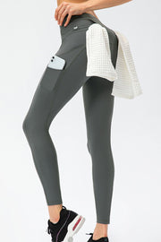 Rear view of charcoal leggings with curved seams and a small zip pocket