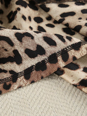 Close view of overlocked seam on leopard-print fabric