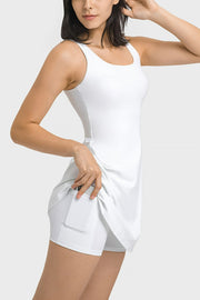 Angled front view of a white tank dress with built-in shorts.