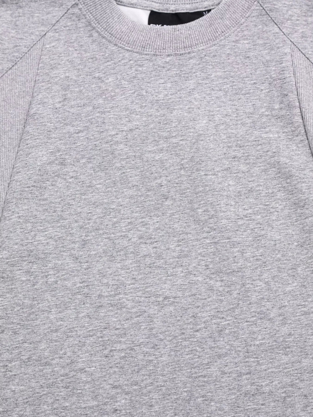 Gray T-shirt sleeve cuff with visible stitching