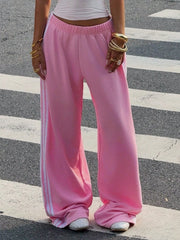 Pink striped track pants shown from the front with hands at sides