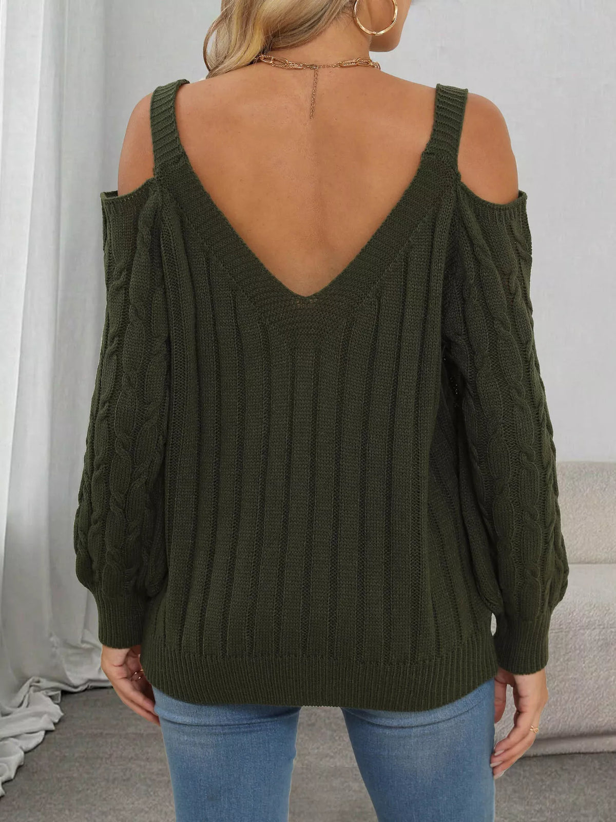 Back view of dark olive sweater showing V neckline and open shoulders