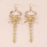Pair of gold-tone scorpion dangle earrings shown upright