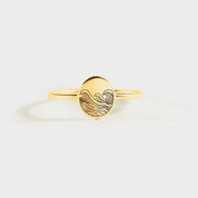 Gold-tone ring with round engraved face, front view
