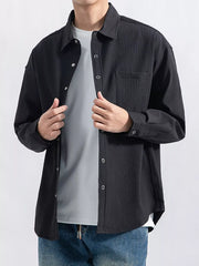 Men's textured long-sleeve button-down shirt shown from the front in a pale color