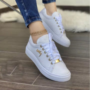 Brown round toe lace-up sneakers with perforated sides and white soles