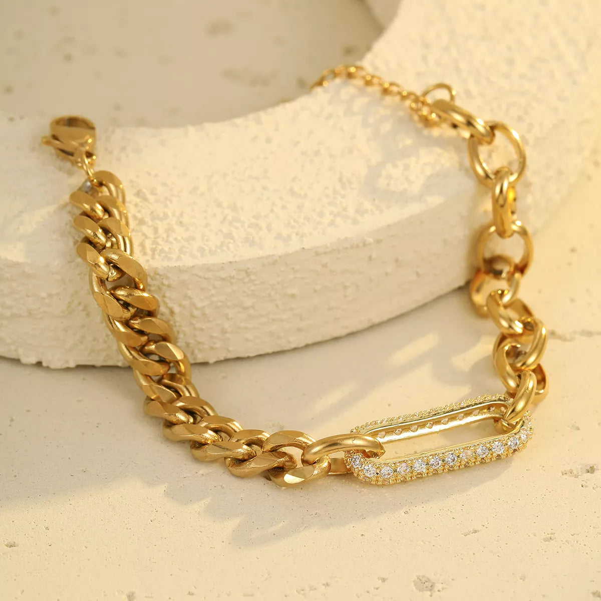 Detail of chunky gold-tone chain and rhinestone centerpiece
