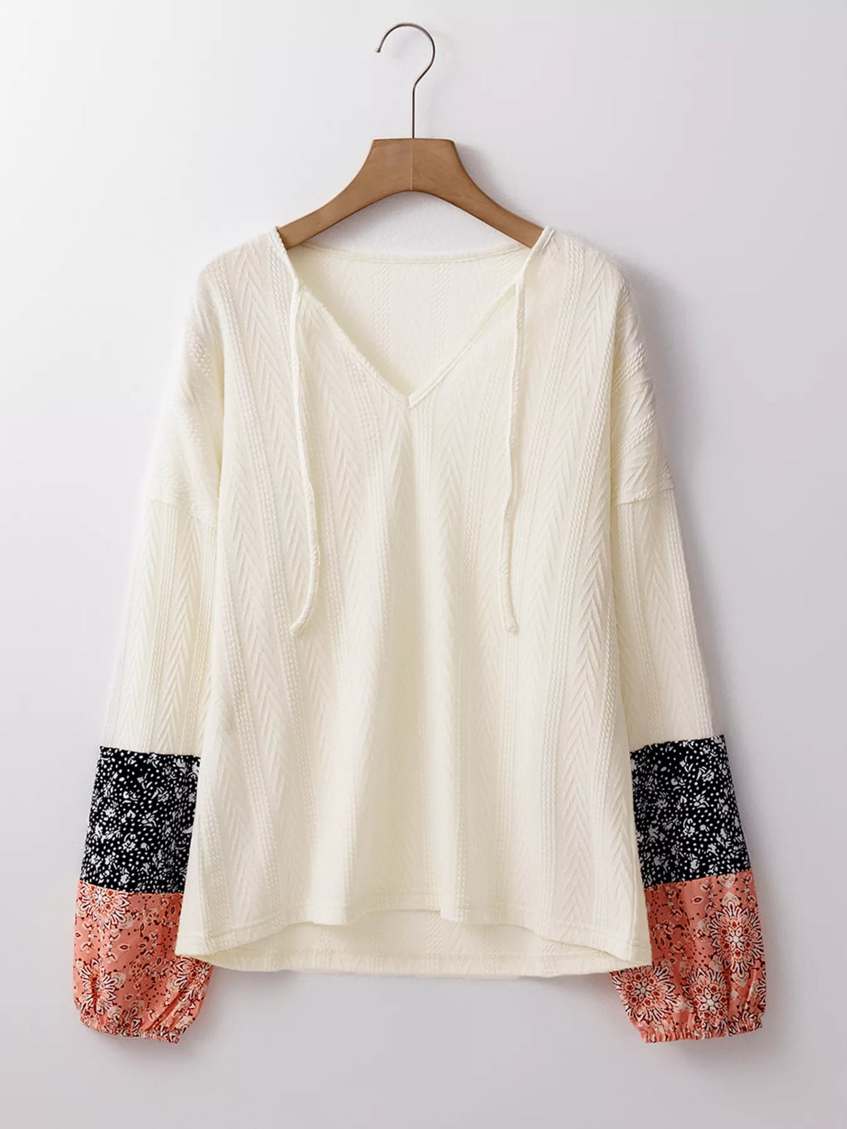 Front product view of ivory blouse with floral cuff patches