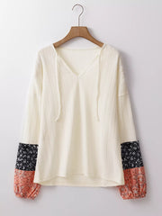 Front product view of ivory blouse with floral cuff patches
