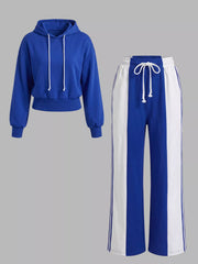Royal blue hoodie and matching colour-block pants displayed together against a grey background.