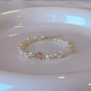 Pearl and crystal bracelet arranged on a pale display dish
