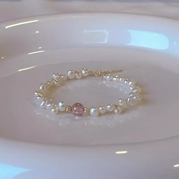 Pearl and crystal bracelet arranged on a pale display dish