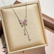 Silver butterfly necklace with pink and clear stones displayed in a jewelry box