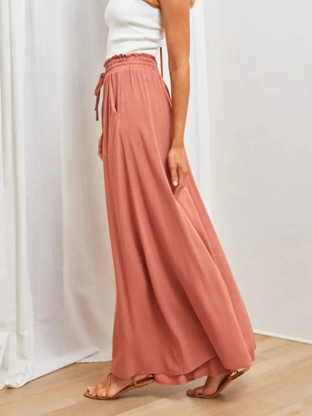 Side view of flowing rose wide-leg pants