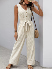 Model wearing striped wide-leg jumpsuit and woven bag