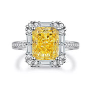 Isolated view of the yellow rectangular center stone and detailed clear-stone setting