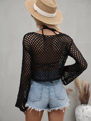 Model wearing the sage green openwork cropped cover-up with long flared sleeves.