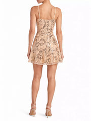 Back view of the beige sequin mini dress showing thin adjustable straps and a straight neckline.