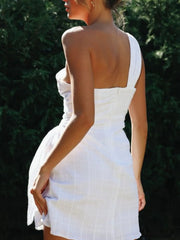 Back view of white one-shoulder dress with exposed shoulder and fitted back