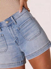 Close side view of light blue denim shorts showing the back pocket and cuff.