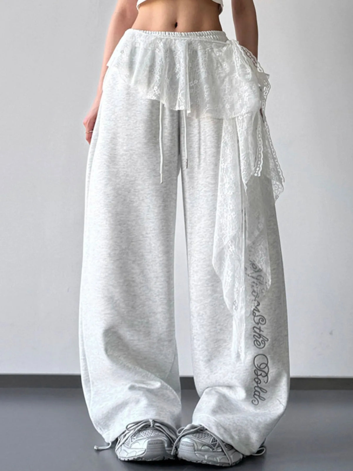 Light gray wide-leg pants styled with a lace overlay