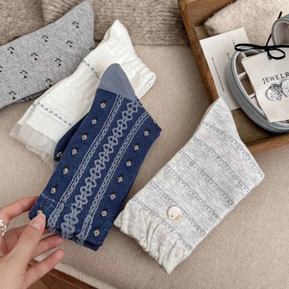 Folded blue, gray and white socks with patterned knit details