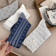 Folded blue, gray and white socks with patterned knit details