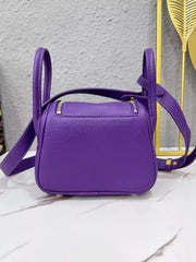 Back view of a purple crossbody bag with zip pockets