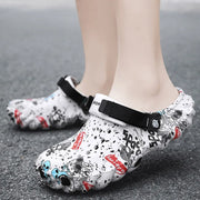 White printed clogs with black straps and ventilation holes, worn from the side