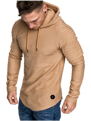 Man wearing a tan hooded pullover with ribbed shoulders and drawstrings.