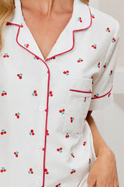 Cherry-Print Collared Top & Shorts Lounge Set: Close-up of cherry-print collared shirt with red piping and buttons.